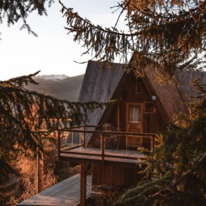 a wooden cabin with a porch and a deck